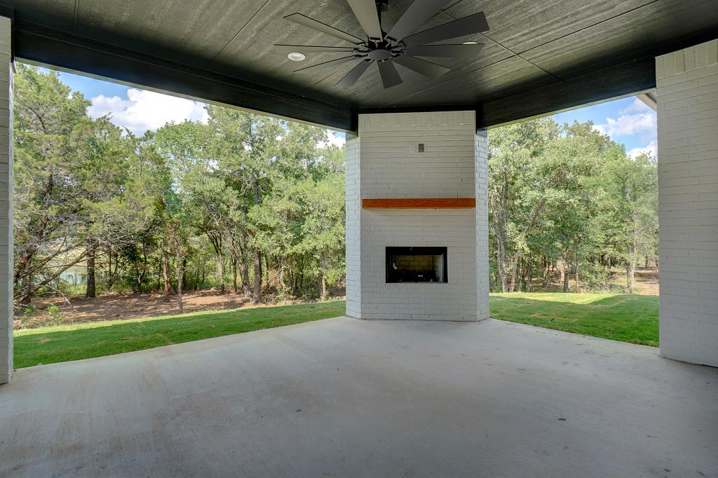 Outdoor fireplace in custom home by Living Stone Construction
